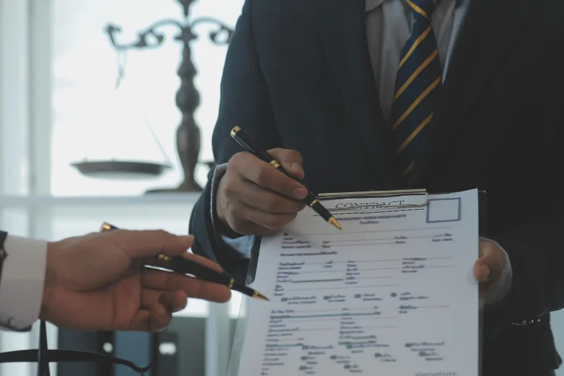 two persons exchanging signature on a document because one party is changing the PRO services provider