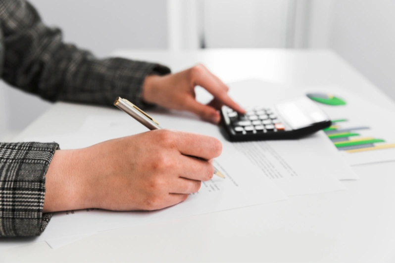 a person is checking his final settlement calculation using calculator